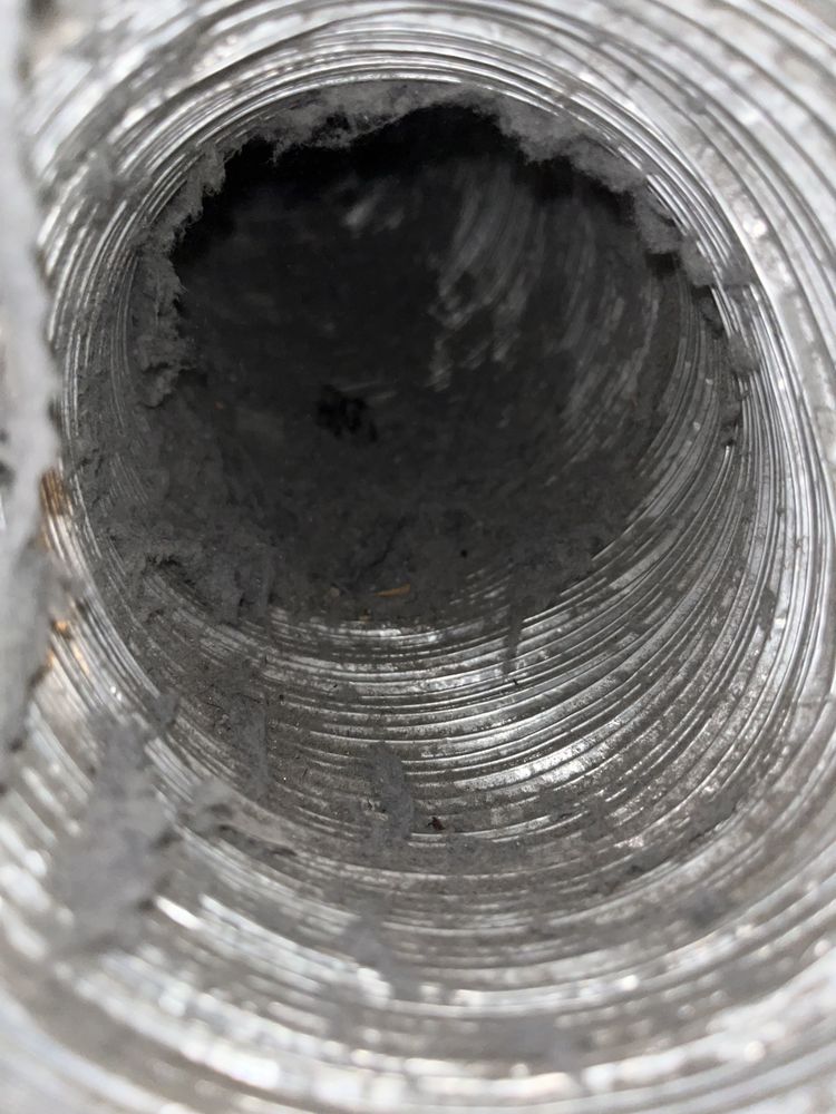 Dust accumulation inside HVAC air duct before professional cleaning
