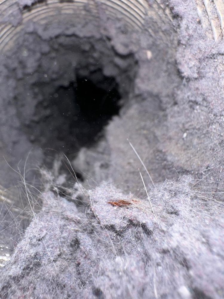 Dust accumulation inside HVAC air duct before professional cleaning